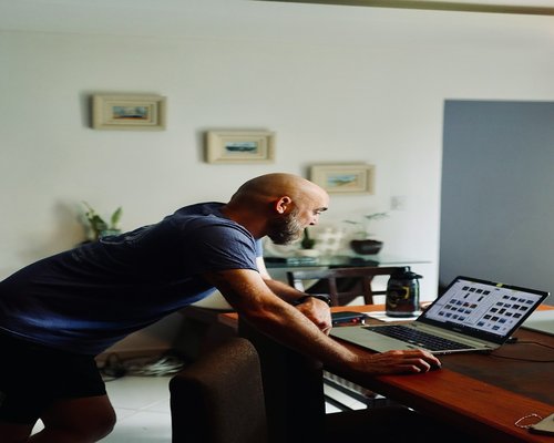 A person working from home, taking a short stretching break