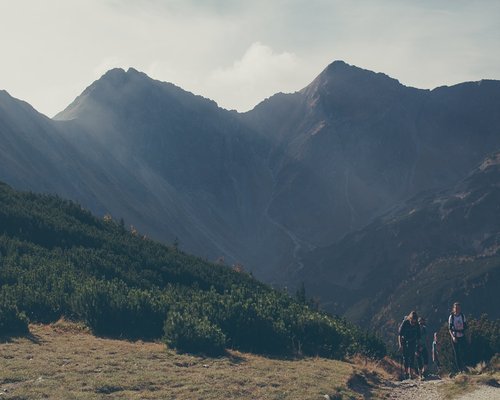 A serene view of people walking calmly on a path in the Tatras mountains